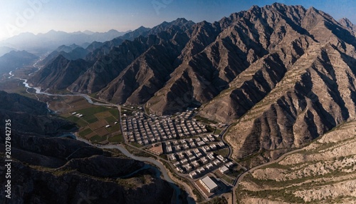 Aerial view of Hatta town aerial cityscape surrounded by Hajar mountains in Hatta enclave of Dubai in the United Arab Emirates.
