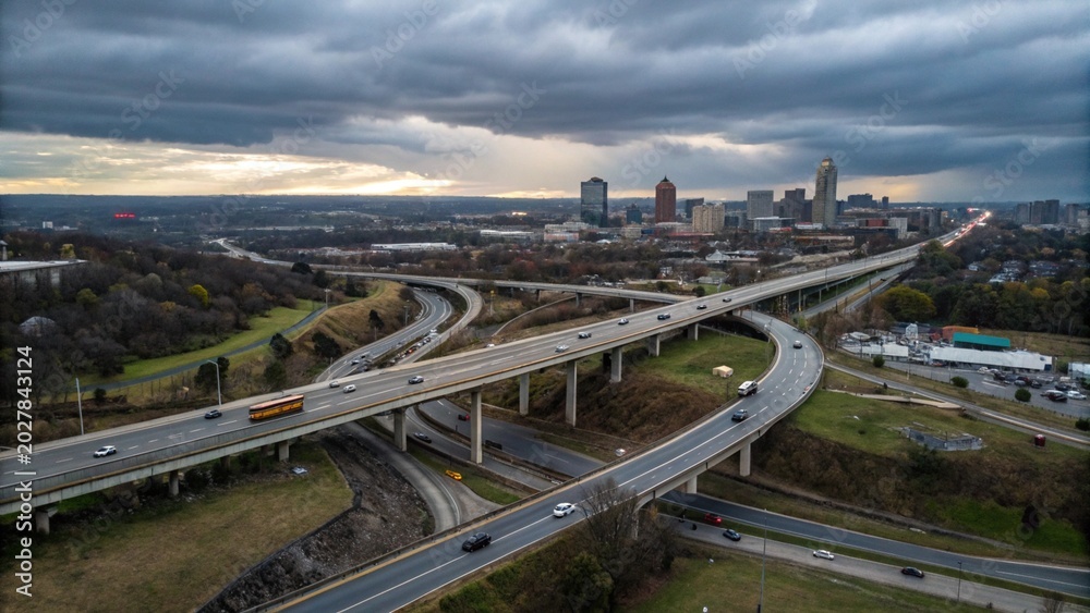 Fototapeta premium Aerial view of highway and overpass in city on a cloudy day