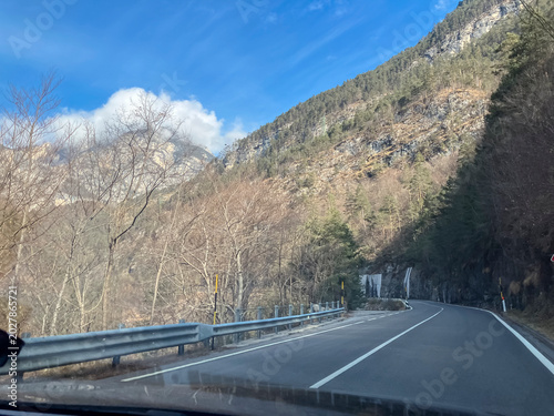Winter Mountain Road Leading Through Snowy Peaks Under a Blue Sky,Italy ,Views from car