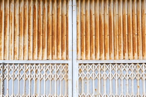 Tableau sur toile Abstract industrial weathered corrugated metal gate texture background with vint