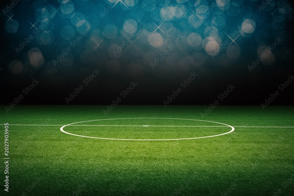 Fototapeta premium Soccer field center circle and markings at night with bokeh lights team sport sports venue play area lighting effect