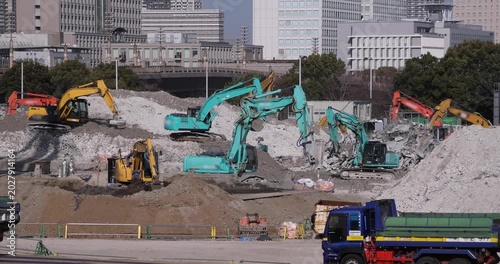 Moving cranes at the under construction in Tokyo in winter telephoto shot