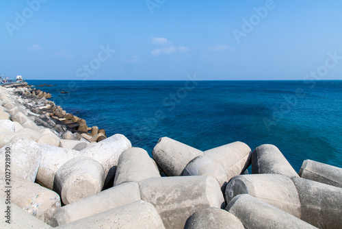 Concrete tetrapods breakwater structures and deep blue ocean