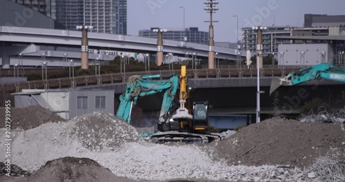 Moving cranes at the under construction in Tokyo in winter telephoto shot