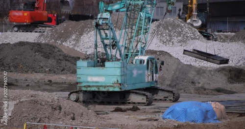 Moving cranes at the under construction in Tokyo in winter telephoto shot
