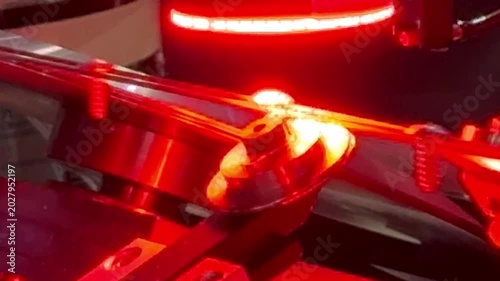 Automated machine vision inspection system checking screw quality with red LED light in factory