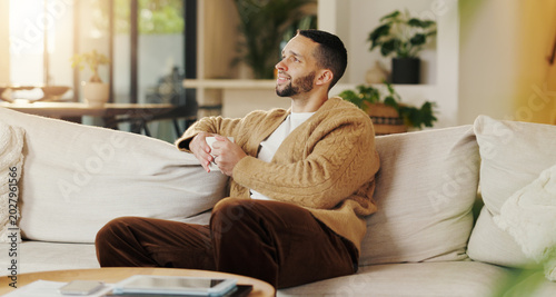 Photos Happy man, relax and daydream with coffee in lounge, chill and comfortable on weekend or reflection