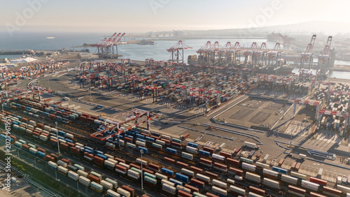 Drone view of shipping containers cranes and port terminal