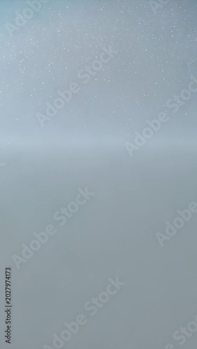 Vertical video: Blue burst starting hatched glyph cycling 10-1 glitching flaring specks signaling