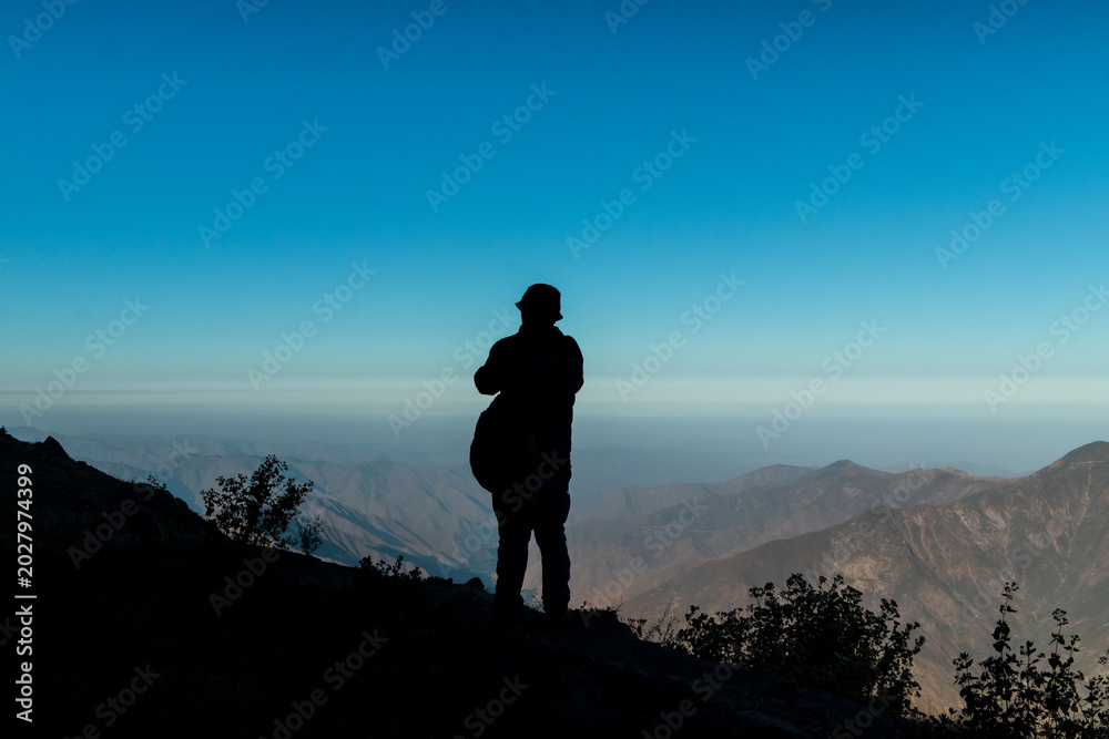 Fototapeta premium Silhouette of traveler overlooking Andean mountains in Peru