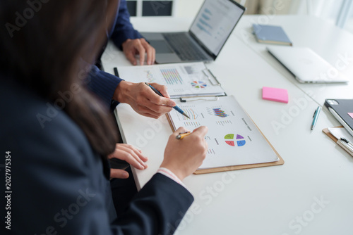 Business professionals analyzing financial report data on desk