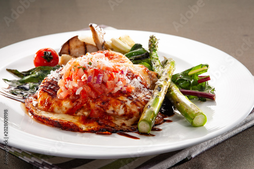 Bild auf Leinwand Baked chicken breast parmigiana with melted mozzarella cheese and tomato sauce,