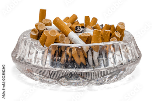фотографія Full crystal ashtray of cigarette butts on white background