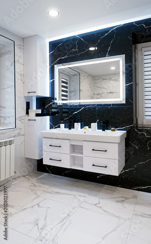 Modern luxury bath with white furniture led mirror and marble stone on floor 