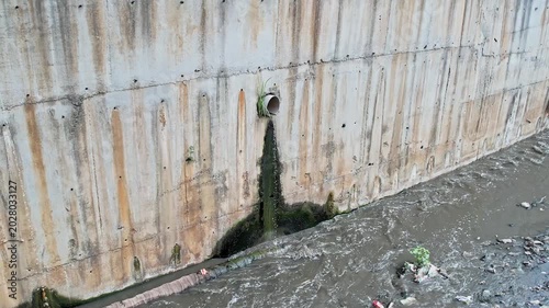 Wide View of Drainage Pipe Discharging dirty water into Polluted Canal