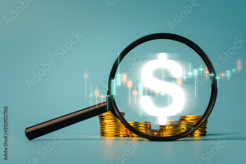 Tableau sur toile Magnifying glass focusing on a glowing bright digital dollar sign over a stack o