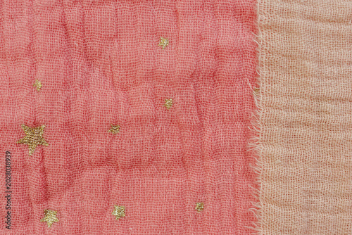 Schilderij op canvas Pink and beige muslin fabric texture with golden star pattern