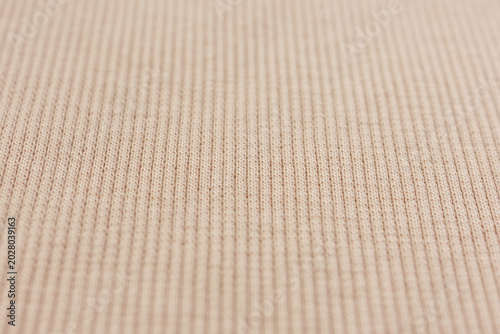 Fotografie Beige ribbed knit fabric texture close up background
