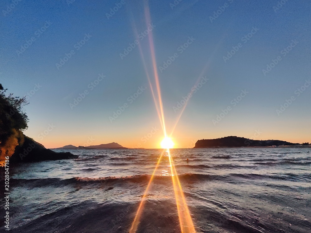 Obraz premium Miseno Sunset Dramatic Sunstar Lens Flare Mediterranean Sea Campi Flegrei Headlands
