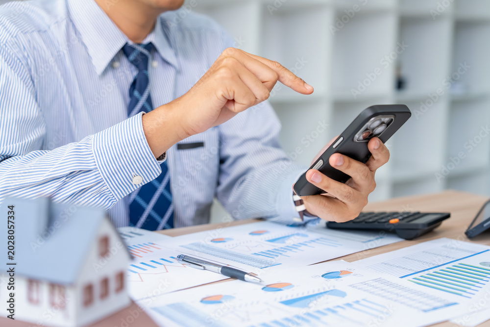 Fototapeta premium Business professional engaging in digital communication office setting smartphone usage collaborative environment close-up view productivity concept