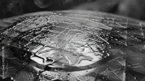 Black and White Closeup of a Melting Substance on a Mirrored Surface with Vapor and Abstract Shapes