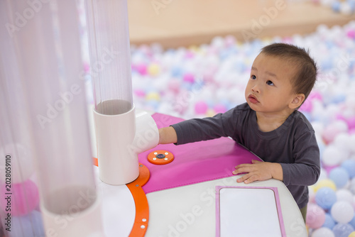 Child playing with plastic balls in science museum