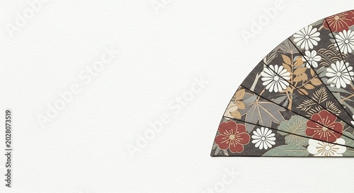 Traditional Japanese fan with floral pattern on white background