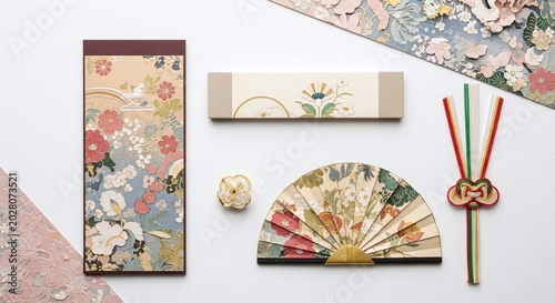 Traditional Japanese fans and floral patterned paper products on white background