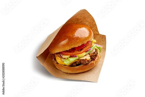 Fresh classic cheeseburger wrapped in craft paper isolated on white background