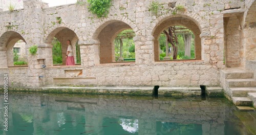 Young Woman Resting in Historic Tvrdalj Castle Courtyard in Stari Grad, Hvar Island, Croatia