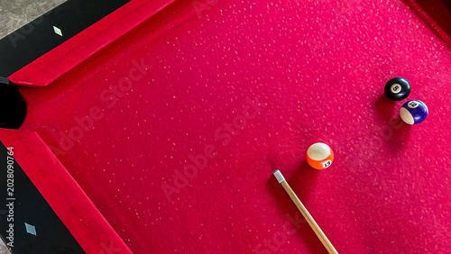 Bilde på lerret Red Billiard Table With Pool Balls And Cue Stick In Modern Game Room, Leisure An