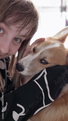 Playful Pembroke Welsh Corgi puppy spending joyful time with a child indoors, highlighting companionship, fun, and warmth in a cozy home environment.