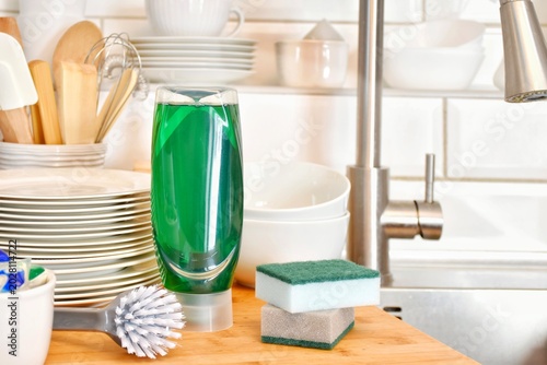 Cuadro en lienzo A bottle of detergent for daily use in the kitchen and clean washed dishes near the kitchen sink