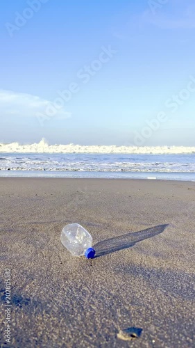 Plastic bottle trash lying on sandy beach