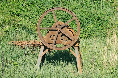 Antique Rusty Agricultural Machine with Flywheel, Abandoned Vintage Farm Equipment Outdoors