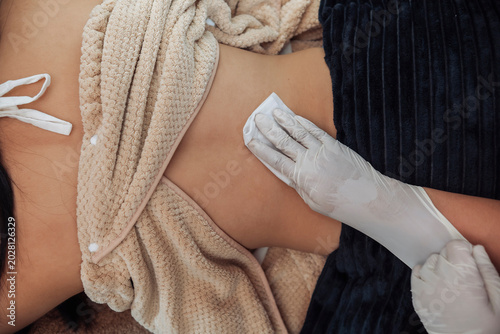 Bild auf Leinwand Overhead view of a client undergoing skin preparation at an aesthetic clinic bef