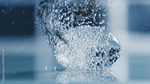 Abstract Water Droplets Collision with Glass Spheres in Slow Motion 4K Close-Up.