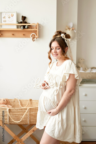 Pregnant Mother With Daughters In Kids Room
