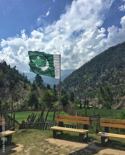 Close-up of a wrinkled and textured fabric flag of Pakistan showing the white crescent moon and five-pointed star on a green background