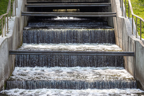 hydraulic structure for water discharge, close-up. A dam release is the controlled release of excess water from a reservoir. water release at the dam.