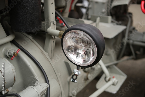 фотографія Industrial machine close up showing headlamp, metal frame and wires, highlightin