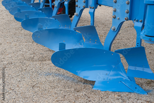 Fényképezés Blue metal plow blades form agricultural equipment for soil tillage and farming