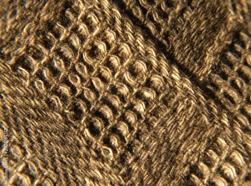 Brown ribbed textile material texture, macro shot of corduroy fabric.