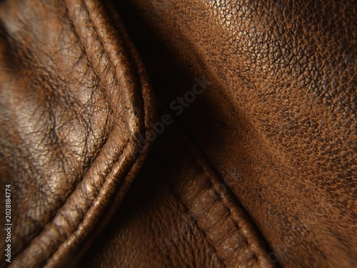 intage brown leather texture with visible seams and natural grain.
