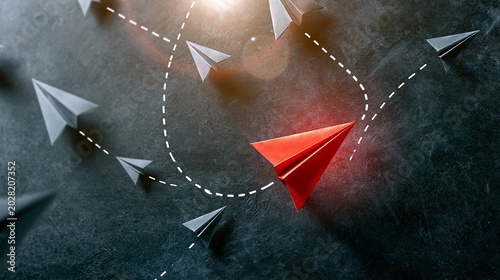Red paper airplane leading  forming its own path  diverging from grey planes  demonstrating innovation and breaking free
