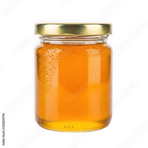 Jar of golden honey with metal lid on shelf