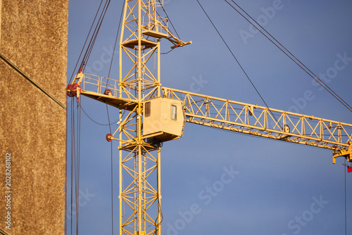 Slika na platnu Orange tower crane jib with trolley and pulleys in action