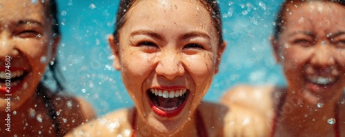 Close Up of Diverse Women Laughing While Splashing Water During Summer Vacation for Joyful Lifestyle Concept and Vibrant Friendship Holiday Fun and Outdoor Emotional Happiness Scene