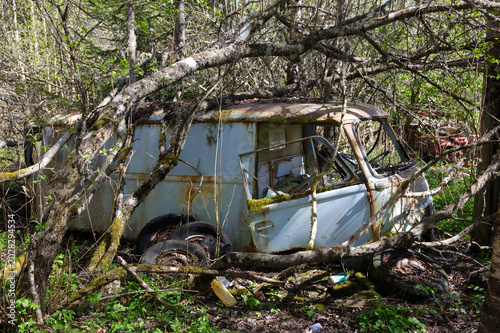 Photography Classic camper van broken down in forest