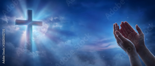 Praying Hands and Glowing Christian Cross in Deep Blue Night Sky, Worship and Faith Spiritual Panoramic Background